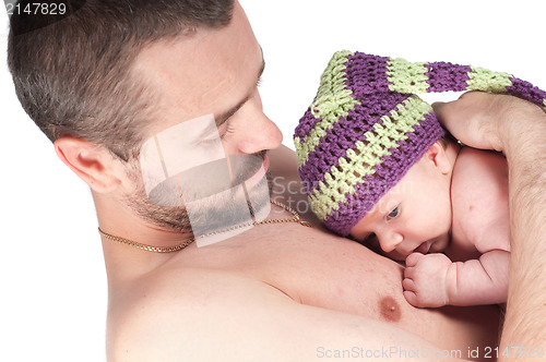 Image of Newborn baby in knitted hat with dad