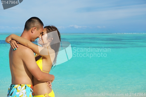 Image of happy young  couple enjoying summer on beach