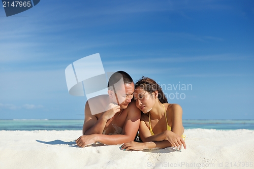 Image of happy young  couple enjoying summer on beach