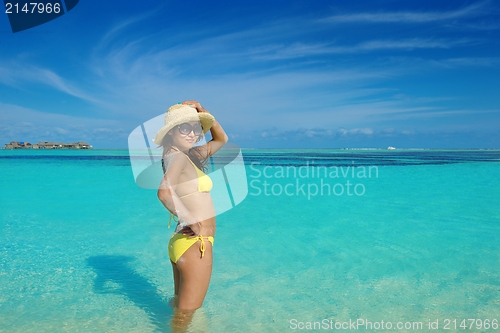 Image of beautiful  woman resting on tropical  beach