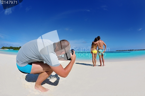 Image of photographer taking photo on beach