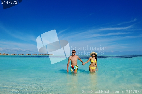 Image of happy young  couple enjoying summer on beach