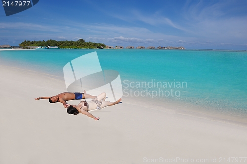 Image of happy young  couple enjoying summer on beach