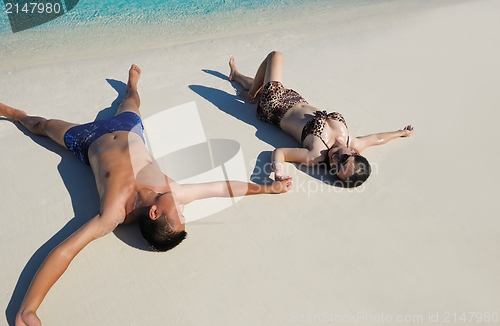 Image of happy young  couple enjoying summer on beach
