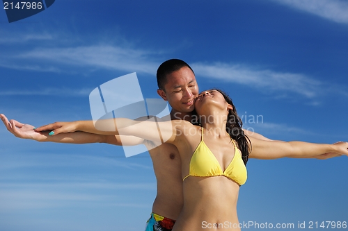 Image of happy young  couple enjoying summer on beach