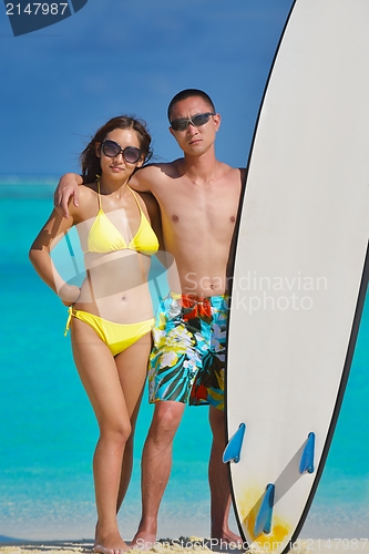 Image of happy young  couple enjoying summer on beach