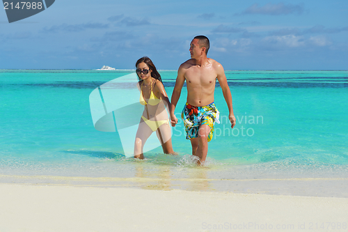 Image of happy young  couple enjoying summer on beach