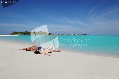 Image of happy young  couple enjoying summer on beach