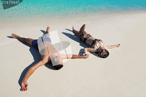 Image of happy young  couple enjoying summer on beach