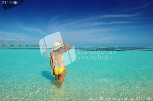 Image of beautiful  woman resting on tropical  beach