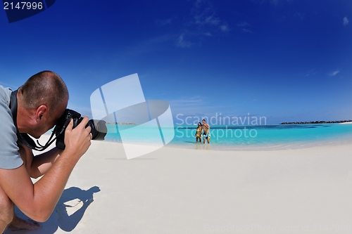 Image of photographer taking photo on beach