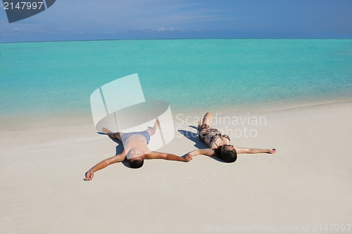 Image of happy young  couple enjoying summer on beach