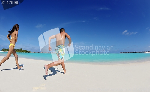 Image of happy young  couple enjoying summer on beach