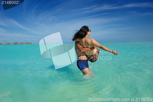 Image of happy young  couple enjoying summer on beach