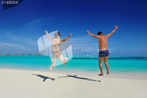 Image of happy young  couple enjoying summer on beach