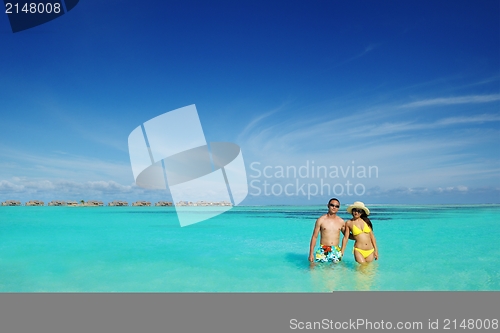 Image of happy young  couple enjoying summer on beach
