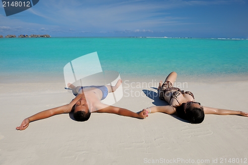 Image of happy young  couple enjoying summer on beach
