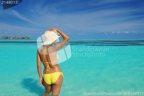 Image of beautiful  woman resting on tropical  beach