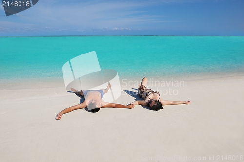 Image of happy young  couple enjoying summer on beach
