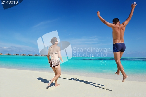 Image of happy young  couple enjoying summer on beach