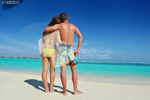 Image of happy young  couple enjoying summer on beach