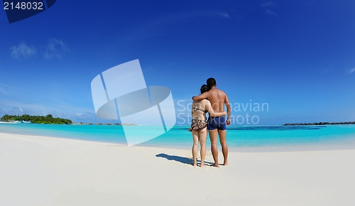 Image of happy young  couple enjoying summer on beach