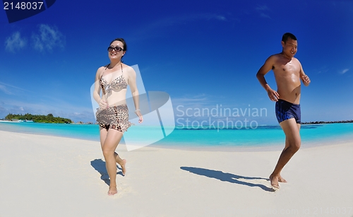Image of happy young  couple enjoying summer on beach
