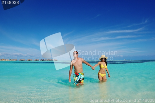 Image of happy young  couple enjoying summer on beach