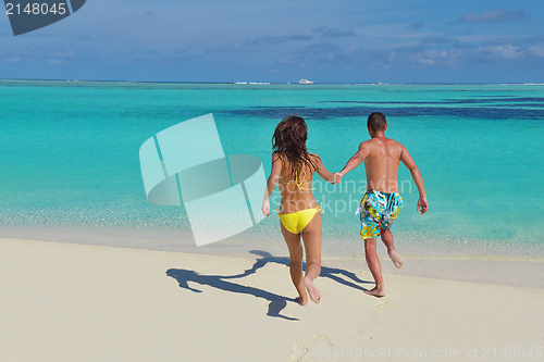 Image of happy young  couple enjoying summer on beach