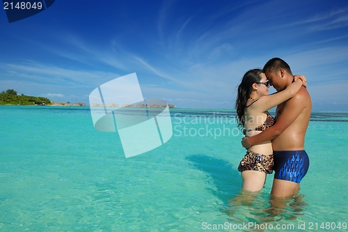 Image of happy young  couple enjoying summer on beach