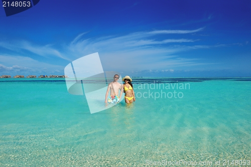 Image of happy young  couple enjoying summer on beach