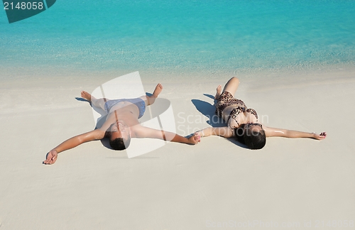 Image of happy young  couple enjoying summer on beach