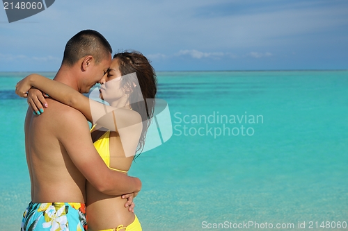 Image of happy young  couple enjoying summer on beach