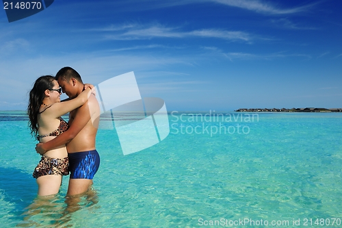 Image of happy young  couple enjoying summer on beach