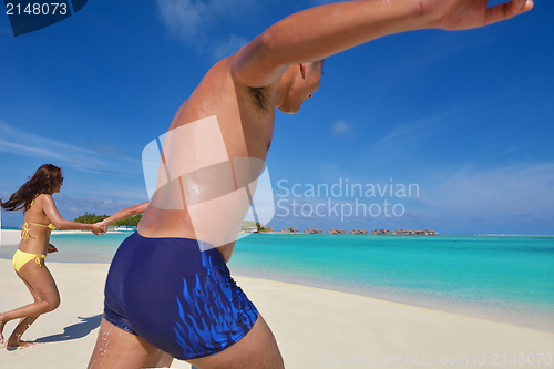 Image of happy young  couple enjoying summer on beach