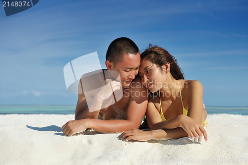 Image of happy young  couple enjoying summer on beach