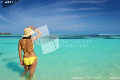 Image of beautiful  woman resting on tropical  beach