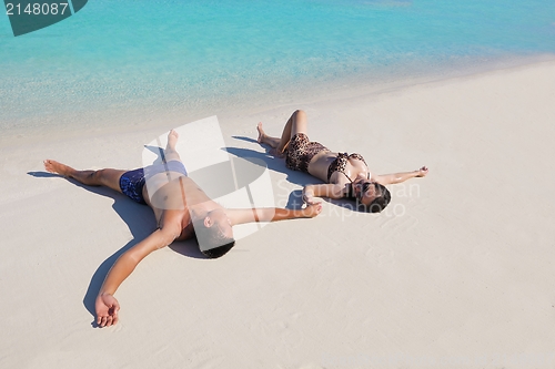 Image of happy young  couple enjoying summer on beach
