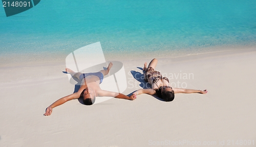 Image of happy young  couple enjoying summer on beach
