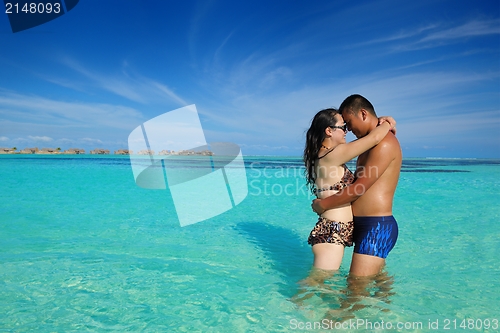 Image of happy young  couple enjoying summer on beach