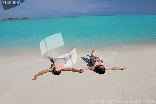 Image of happy young  couple enjoying summer on beach