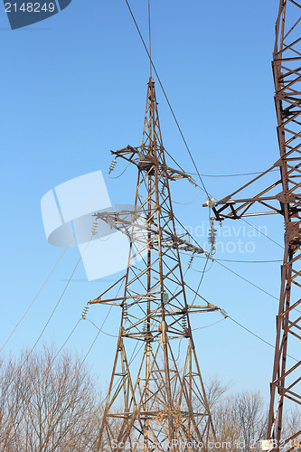 Image of high voltage post against the blue sky