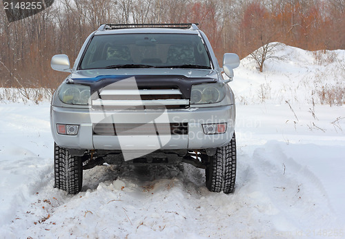 Image of Snowy winter road ahead an unrecognizable car