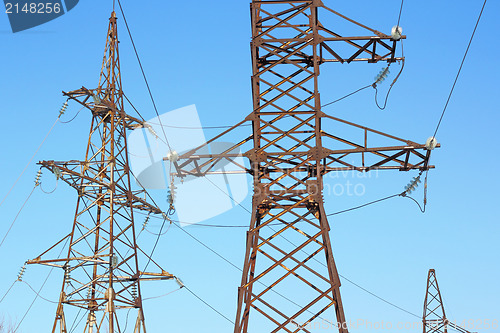 Image of high voltage post against the blue sky