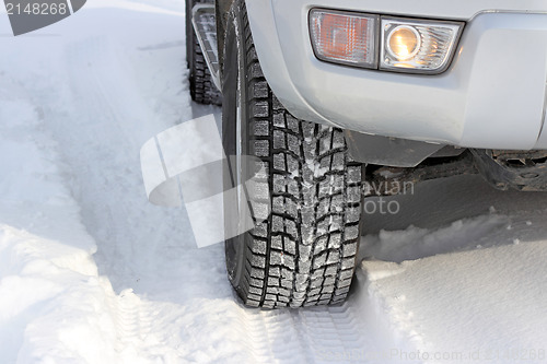 Image of Snowy winter road ahead an unrecognizable car