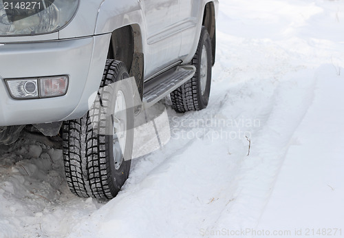 Image of Snowy winter road ahead an unrecognizable car