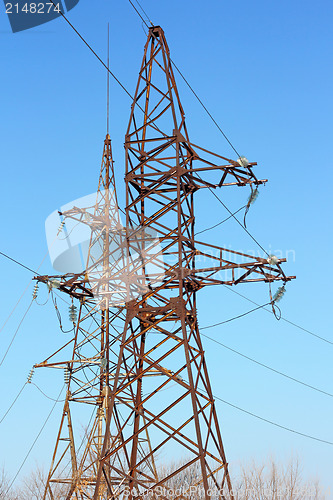 Image of high voltage post against the blue sky