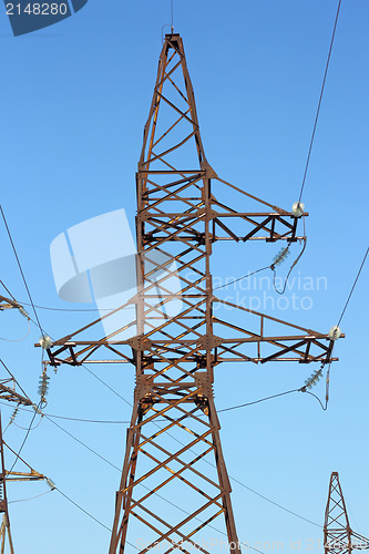 Image of high voltage post against the blue sky