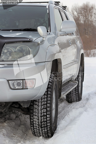 Image of Snowy winter road ahead an unrecognizable car