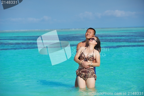 Image of happy young  couple enjoying summer on beach